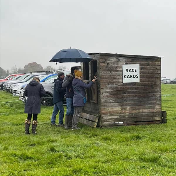 Visitors picking up race cards